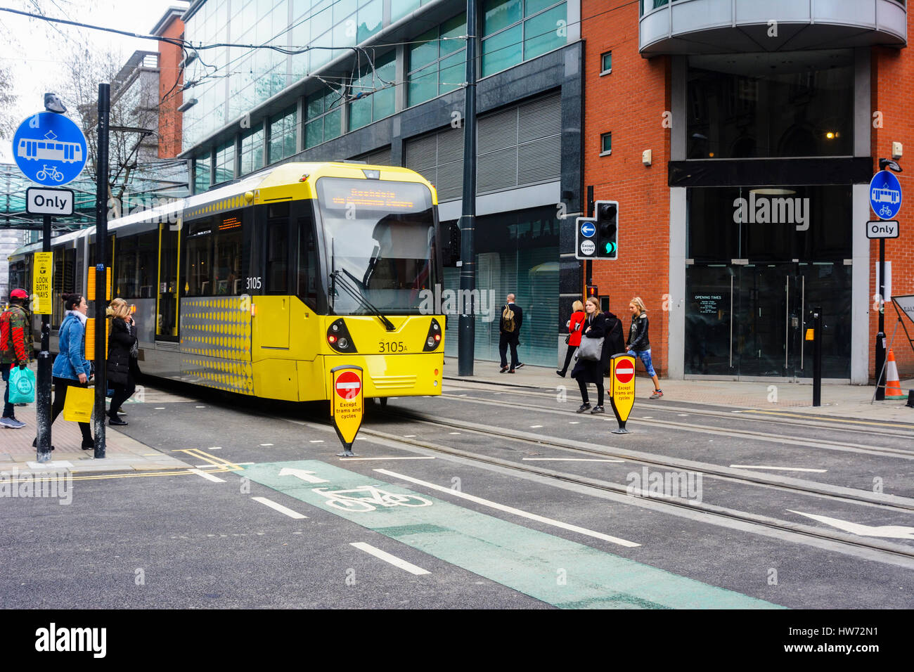 Metrolink trams in Corporation street, Manchester city centre passing the Arndale centre. Stock Photo