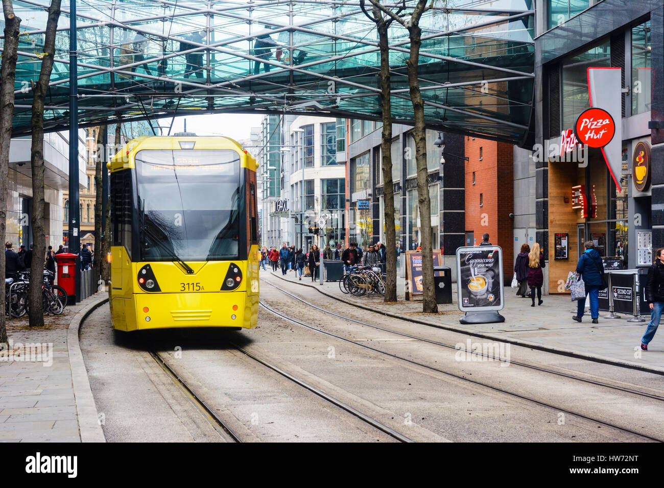 Metrolink trams in Corporation street, Manchester city centre passing the Arndale centre. Stock Photo