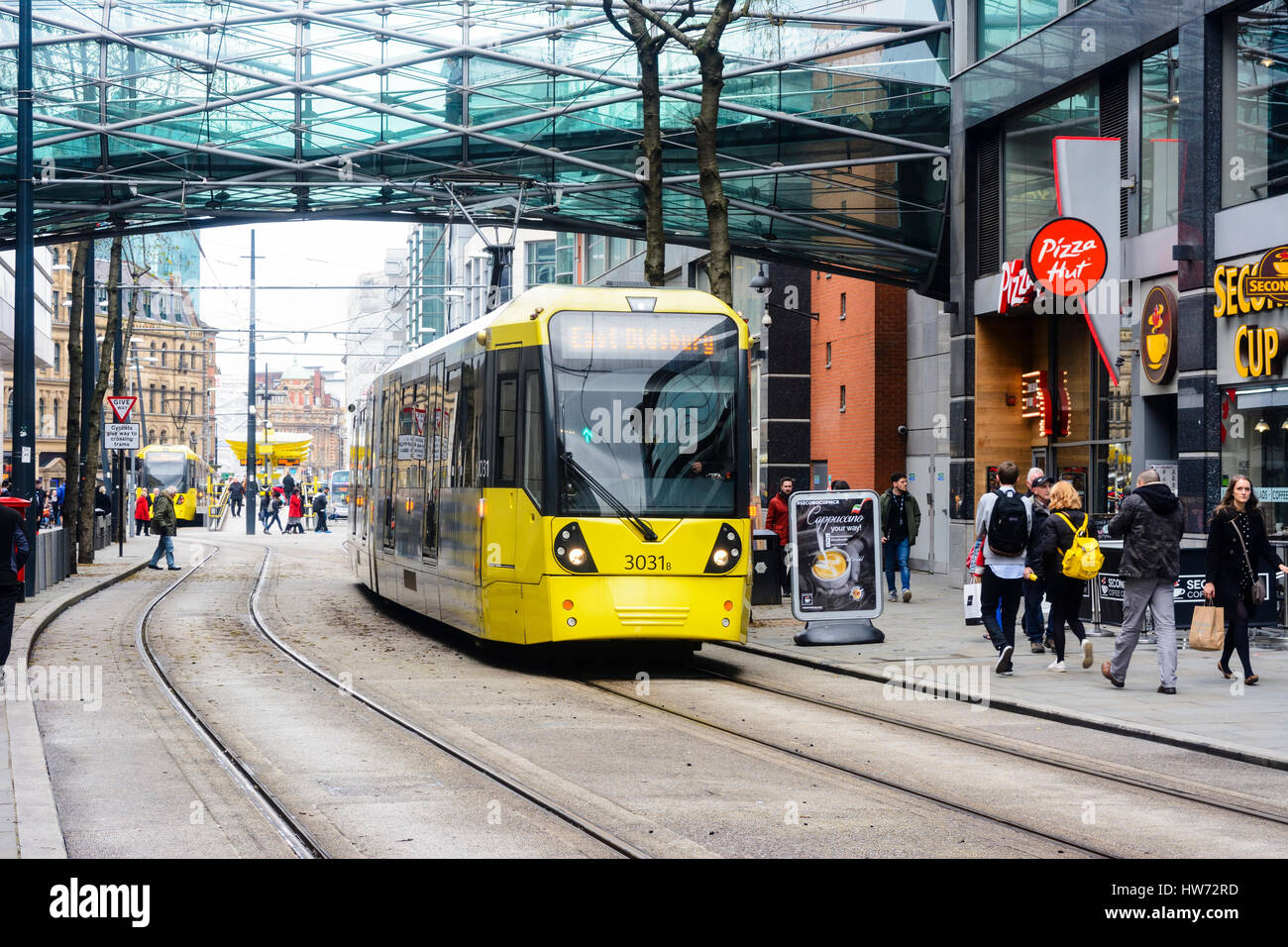 Metrolink trams in Corporation street, Manchester city centre passing the Arndale centre. Stock Photo
