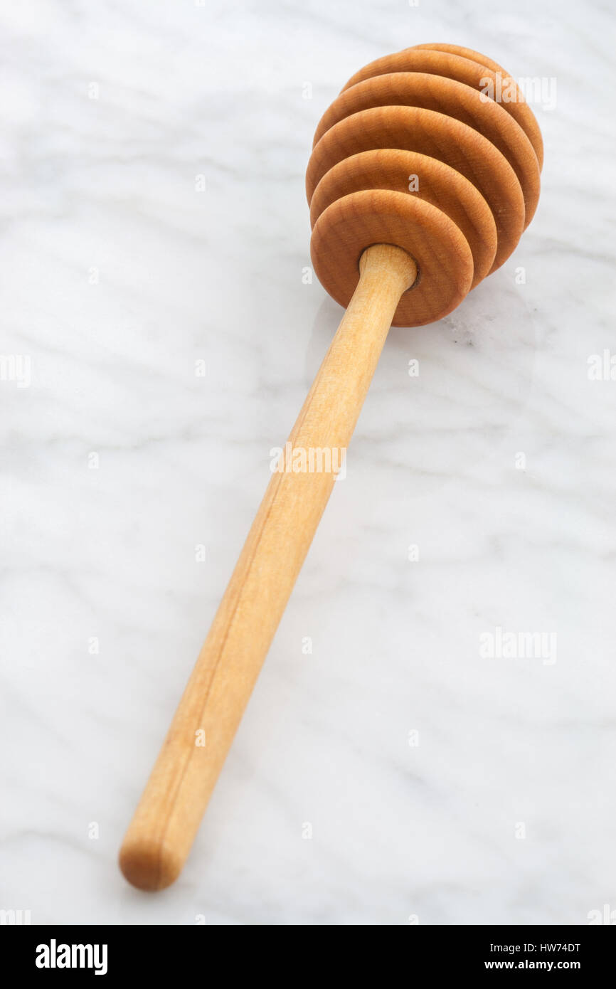 honey dipper on carrara marble countertop Stock Photo Alamy