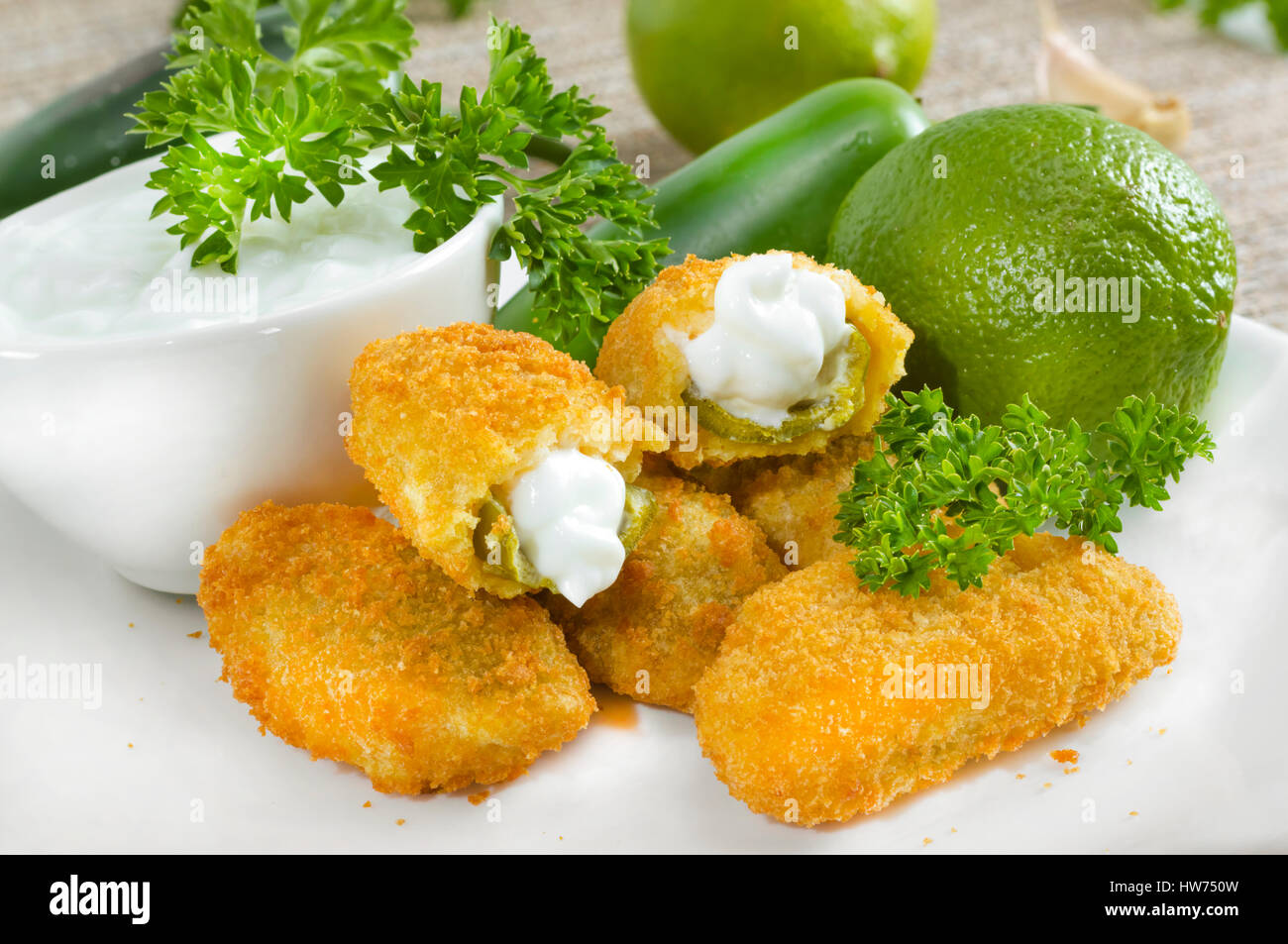 Mexicanamerican jalapeno poppers served with lime Stock Photo Alamy