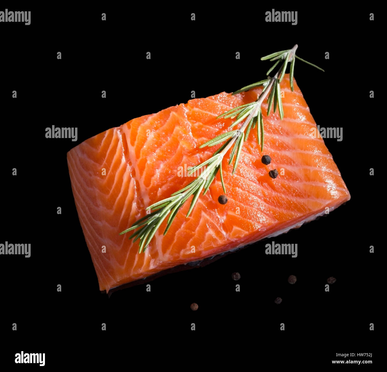 Raw salmon steak isolated on black background with reflection. Stock Photo