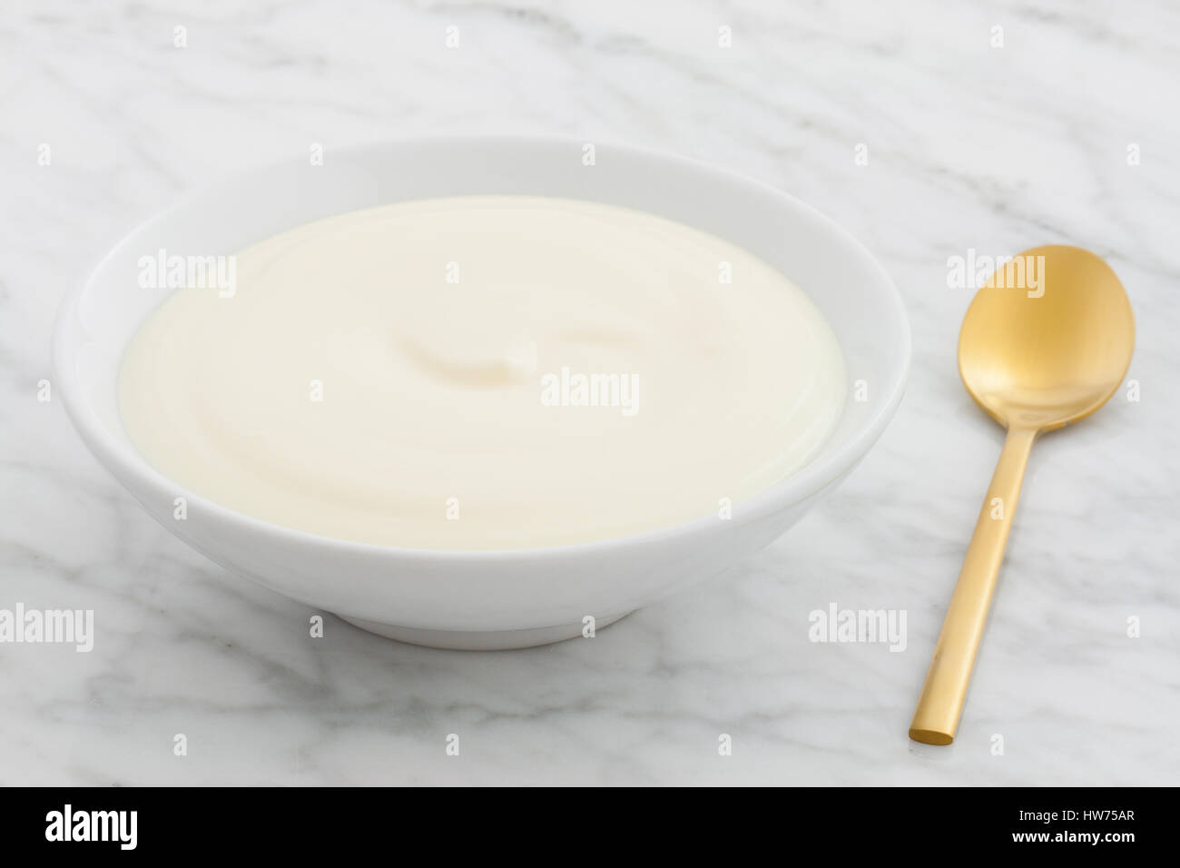 styled greek yogurt on carrara marble countertop Stock Photo
