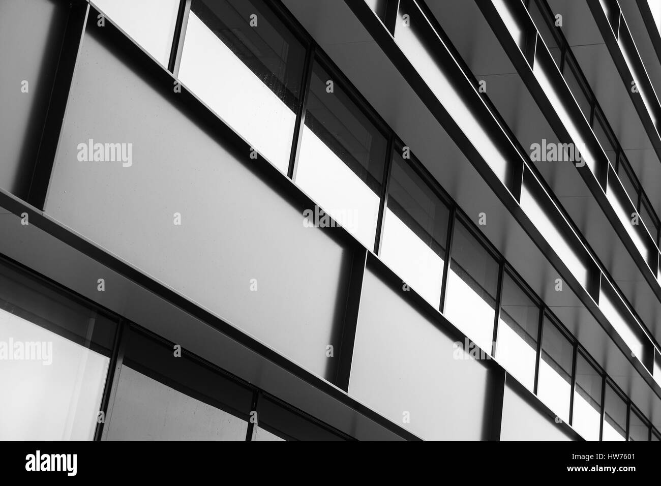 Modern industrial building facade abstract fragment, shiny windows in steel structure, black and white Stock Photo