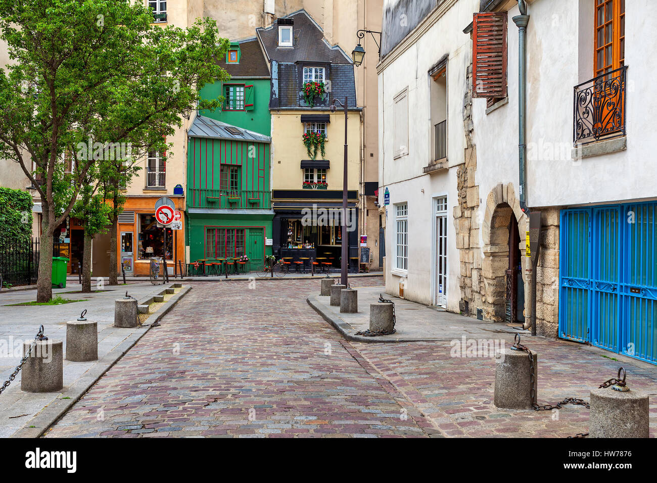 View of narrow cobblestone street and typical parisian architecture in Paris, France. Stock Photo