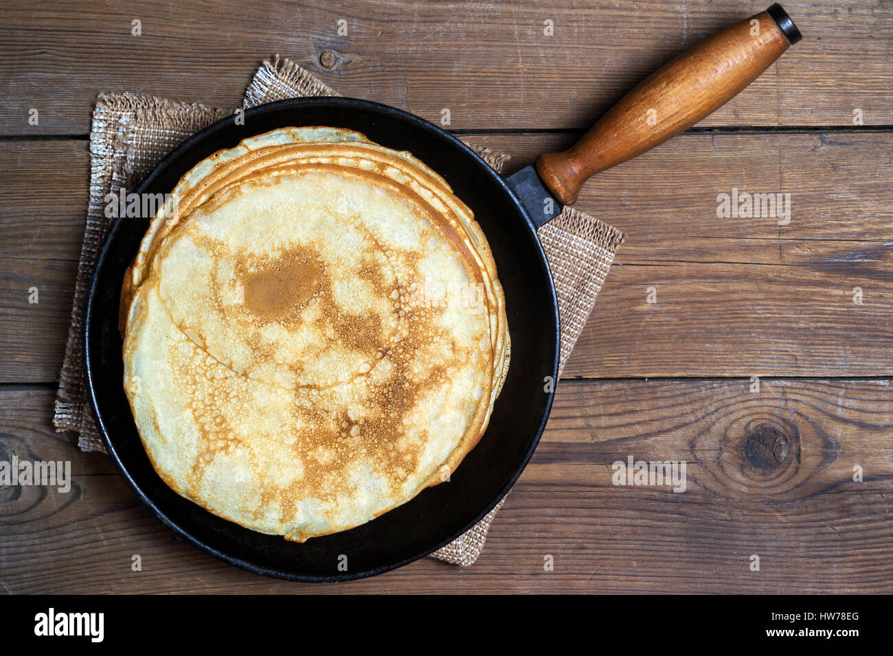 Stack of pancakes on a cast-iron frying pan. Top view. Flat lay Stock Photo