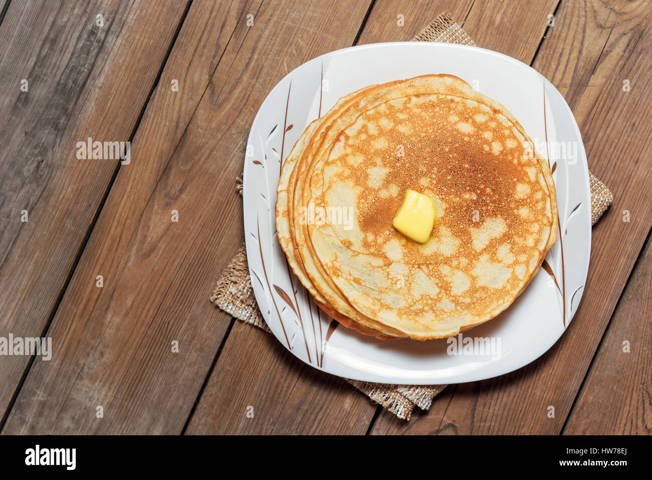 Stack of pancakes on a plate with butter. Rustic style. Top view. Flat lay Stock Photo