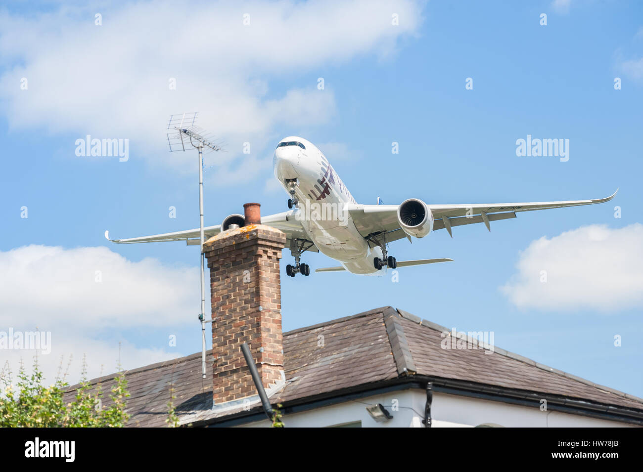 Qatar Airways Airbus A350 on landing approach over rooftops to participate at the Farnborough Airshow,  UK Stock Photo