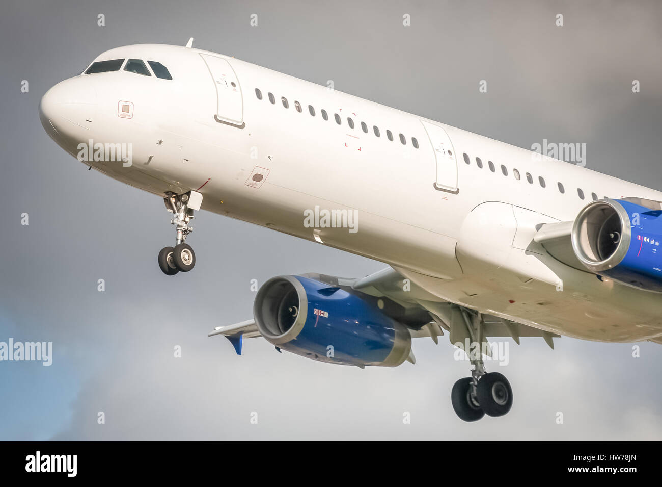 closeup of an unmarked passenger aircraft about to land Stock Photo