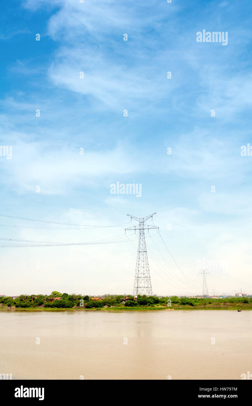Electricity pylon against blue cloudy sky Stock Photo - Alamy