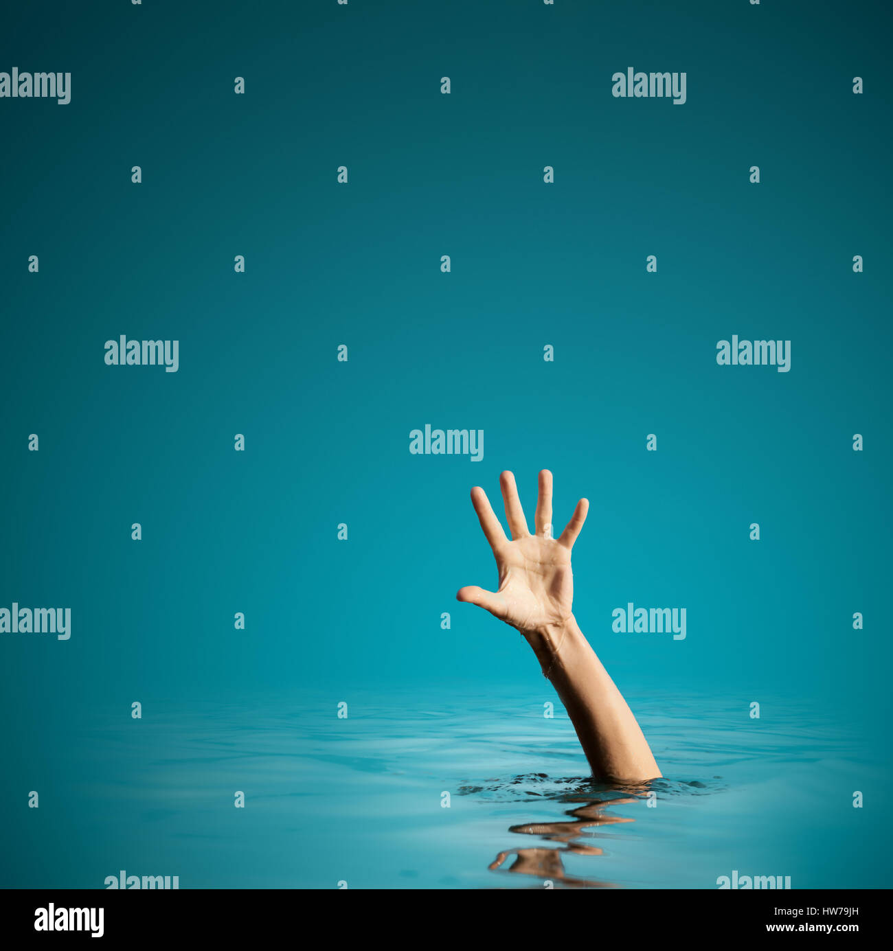 Hand on sea water background asking for help Stock Photo