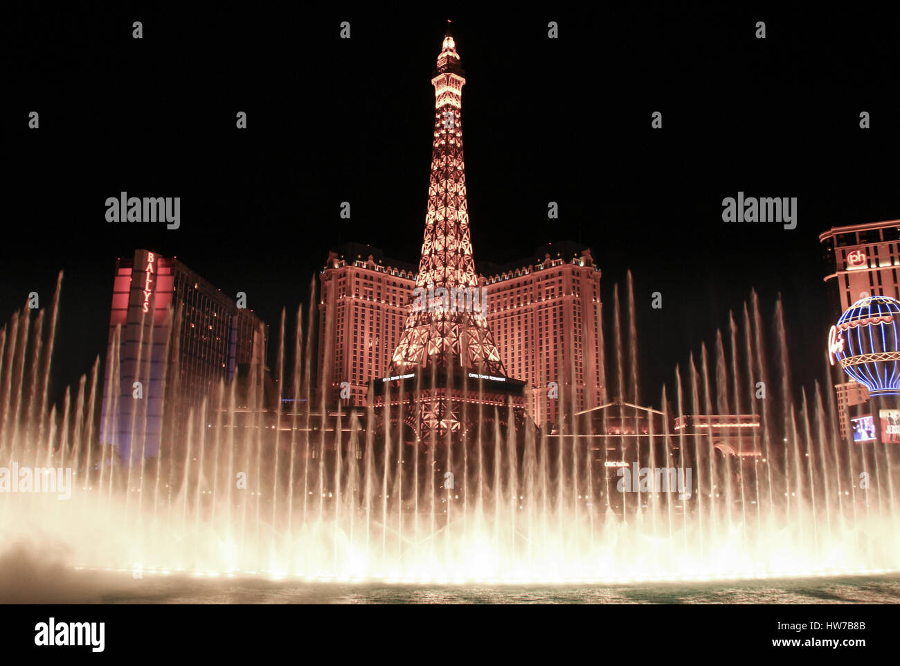 LAS VEGAS, USA - April 08 2014 : Night view of the dancing fountains of Bellagio and the Eiffel Tower replica of Paris hotel in Las Vegas Nevada Stock Photo