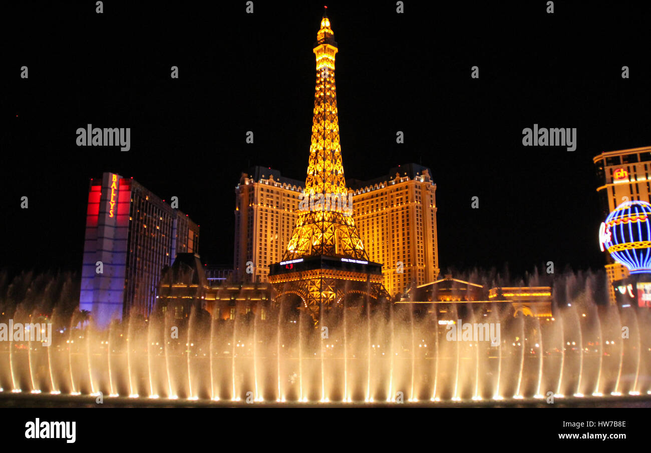 LAS VEGAS, USA - April 08 2014 : Night view of the dancing fountains of Bellagio and the Eiffel Tower replica of Paris hotel in Las Vegas Nevada Stock Photo