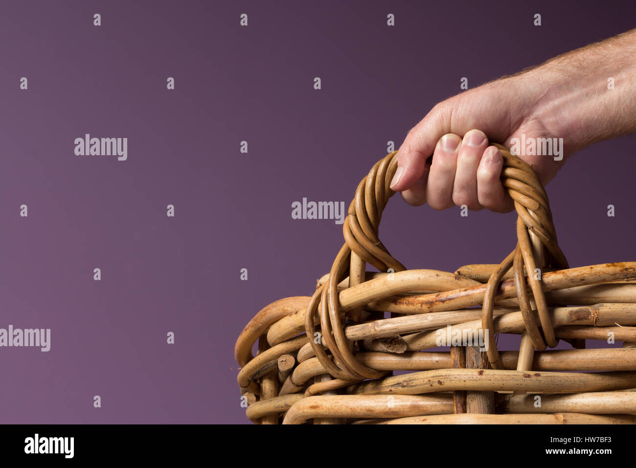 Hand gripping a large cane basket handle Stock Photo Alamy
