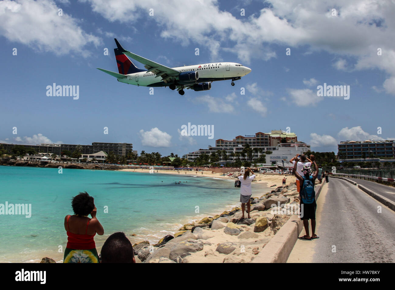 Airplane Delta is landing on Princess Juliana International Airport, over Maho Bay Beach seen in St.Martin/St.Maarten. Stock Photo