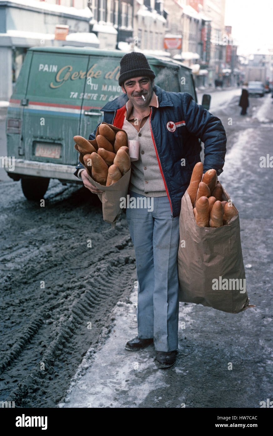 Bread delivery man with gros baguette, Quebec Province, Canada Stock
