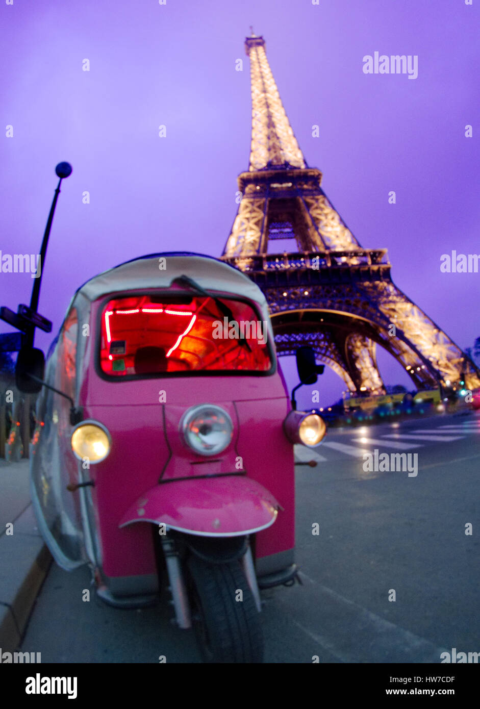 End afternoon: Beautiful pink car in front of Eiffel Tower Stock Photo