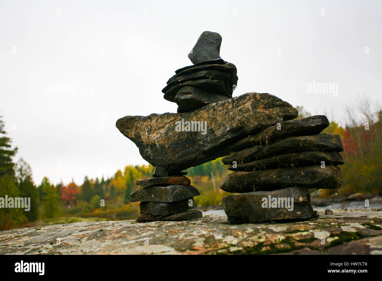 An Inukshuk on the Rocks in Whitney, Ontario Stock Photo