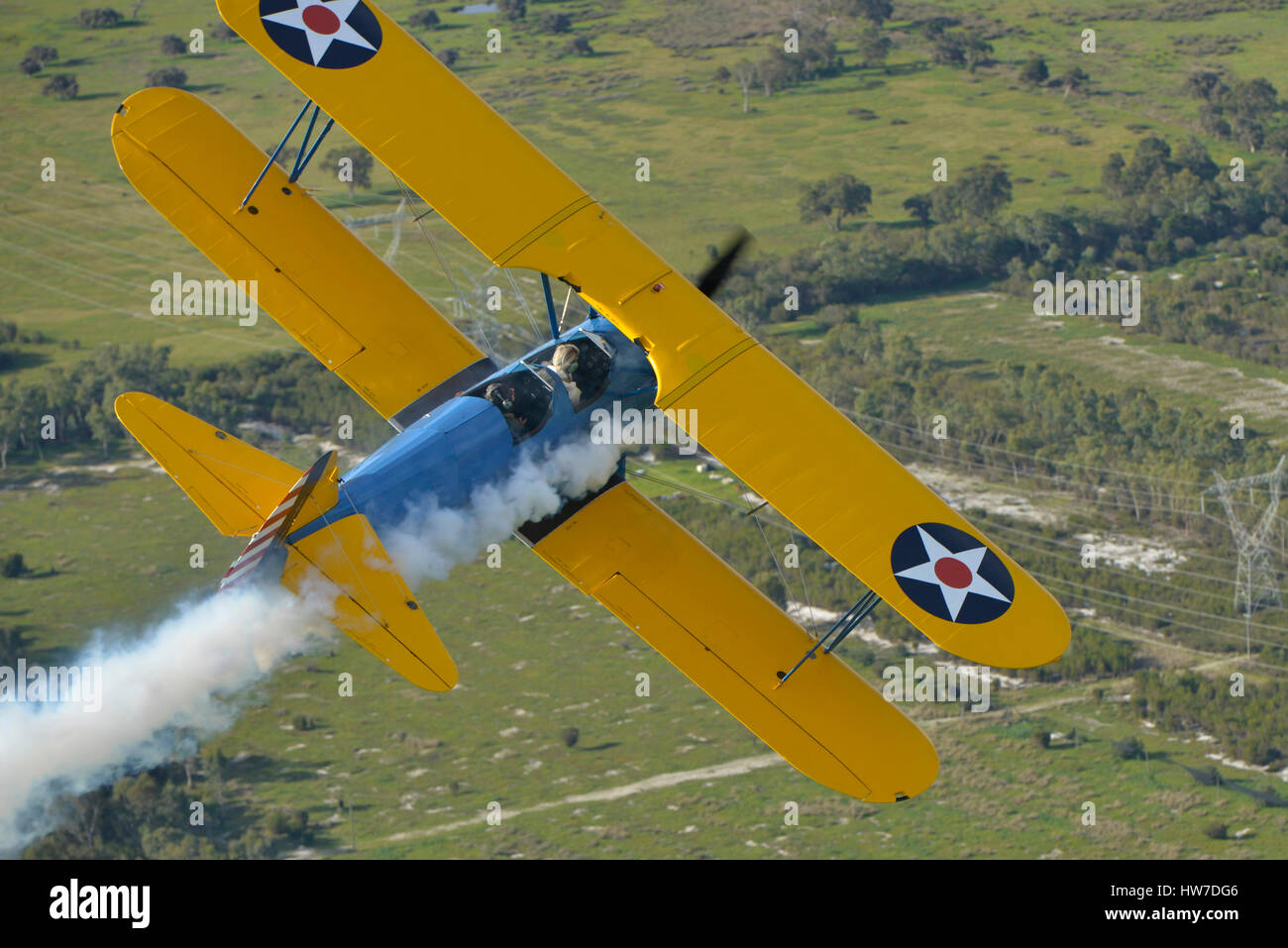 Aerial photo shoot of Boeing stearman biplane with smoke. Western Australia Stock Photo