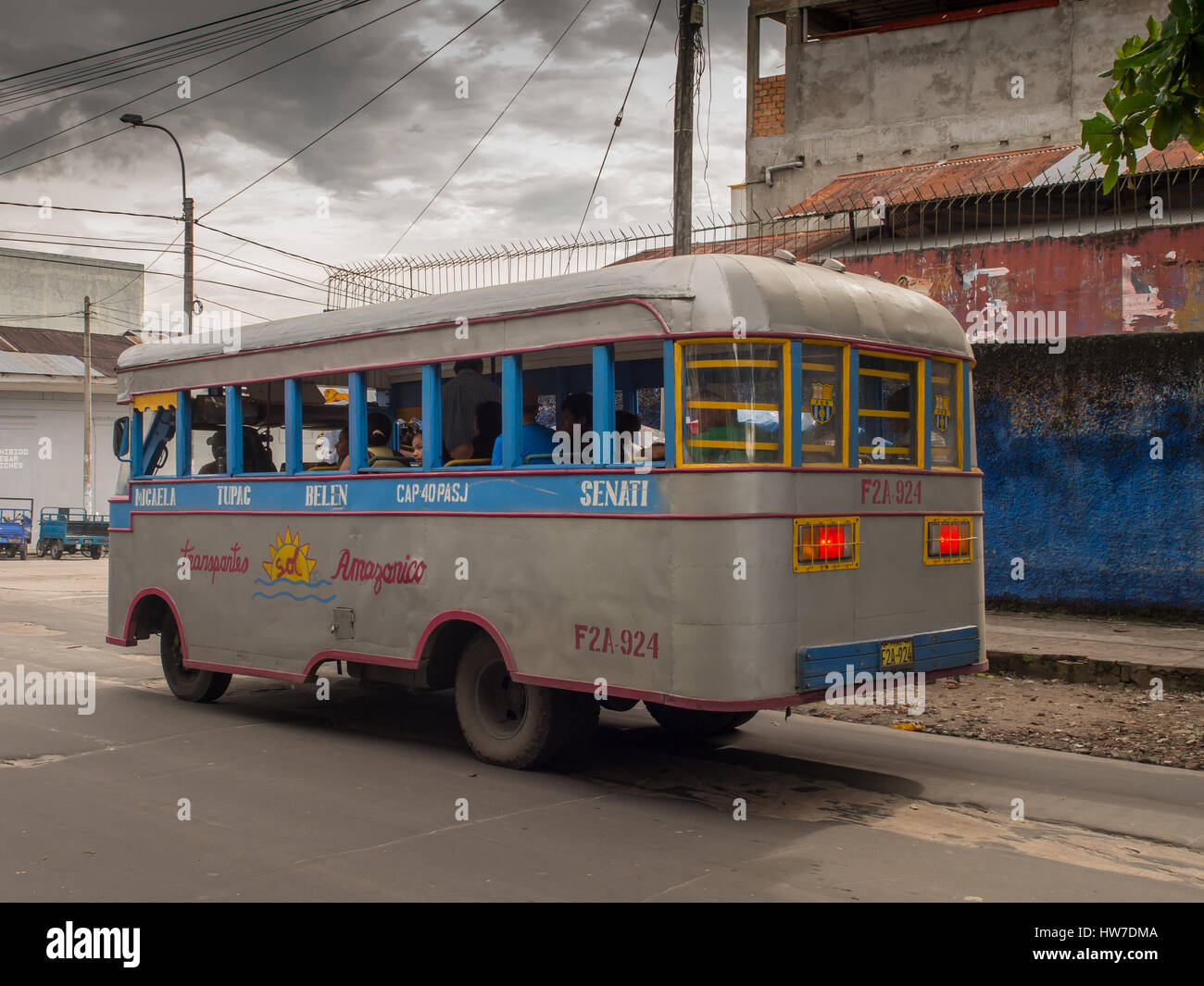 Iquitos, Peru- May 14, 2016: Corolful bus on street of a small southern town. Stock Photo