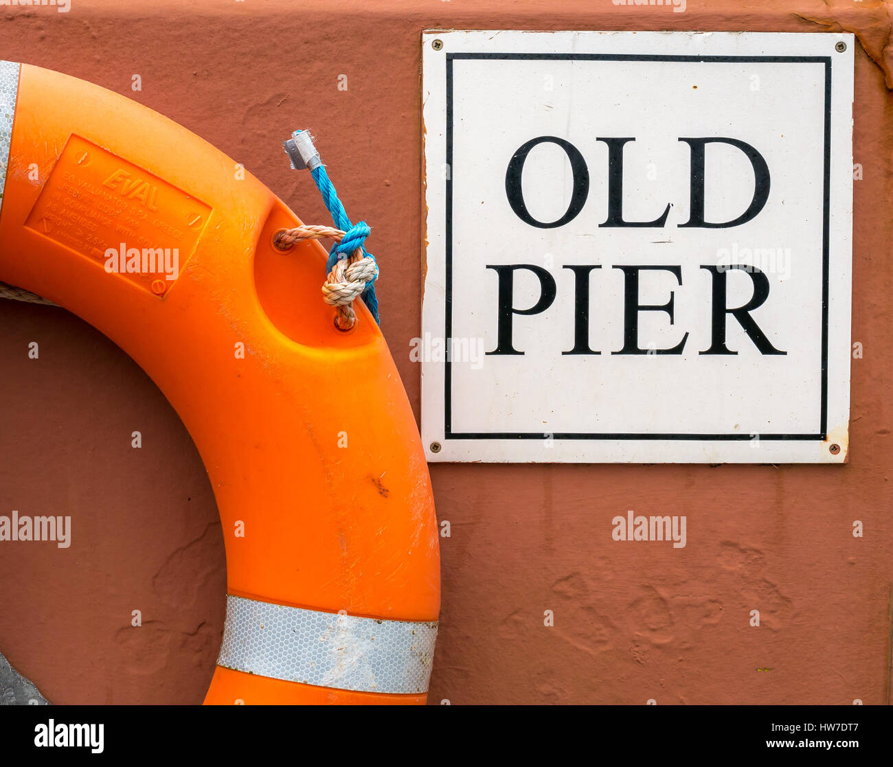 Close up of old pier sign and life belt in harbour wall, North Berwick, East Lothian, Scotland, UK Stock Photo