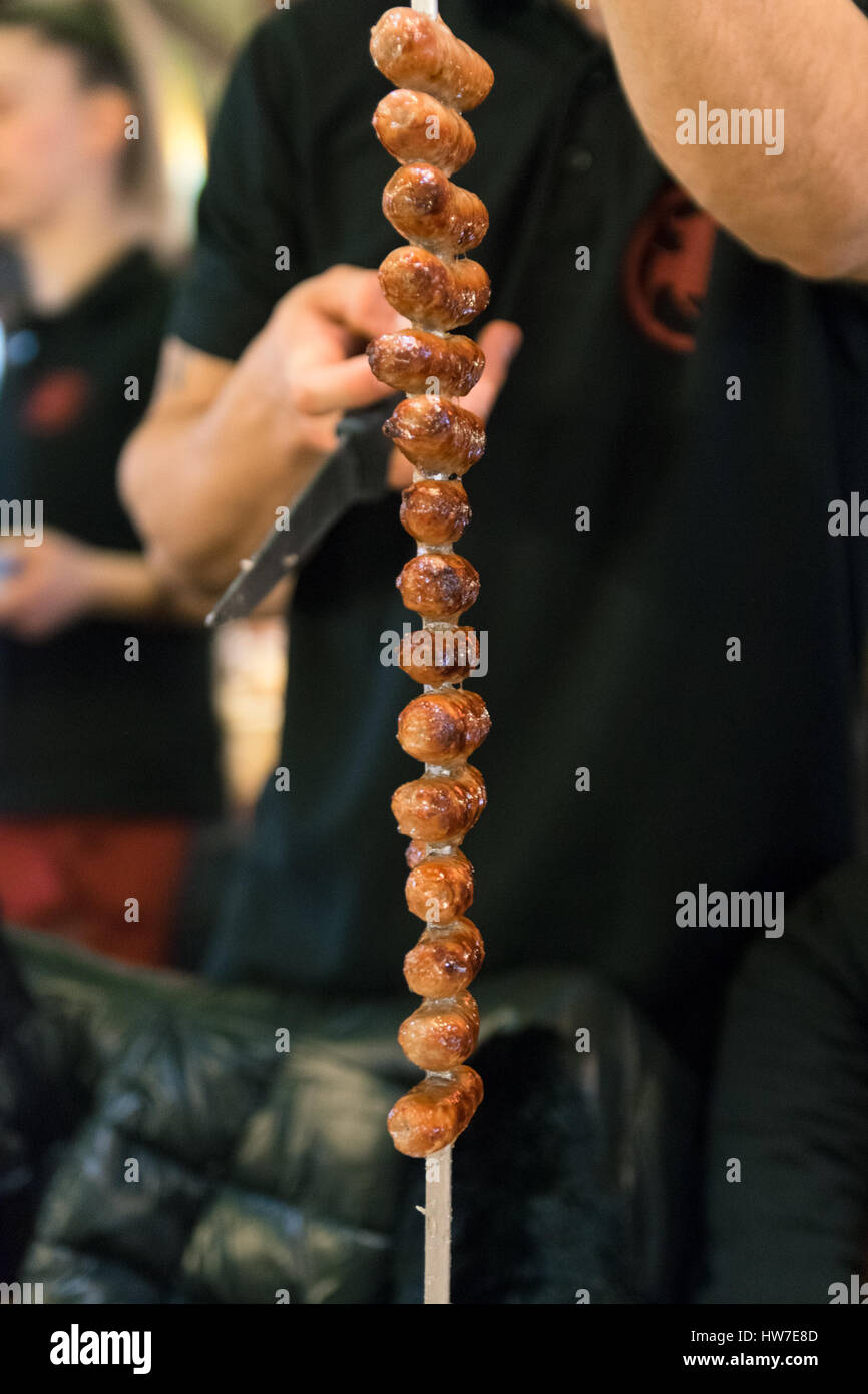 Meat skewered on a spit served to the table in a Brazilian restaurant