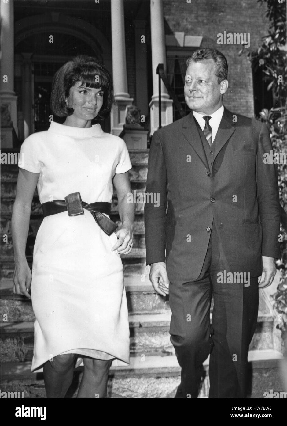 Former first lady Jacqueline Bouvier Kennedy left walks West Berlin Mayor Wily Brandt right to his waiting car in front of her Georgetown home in Washington DC on May 19 1964. Mayor Brandt took time out from his schedule to pay courtesy call on Mrs. Kenne Stock Photo