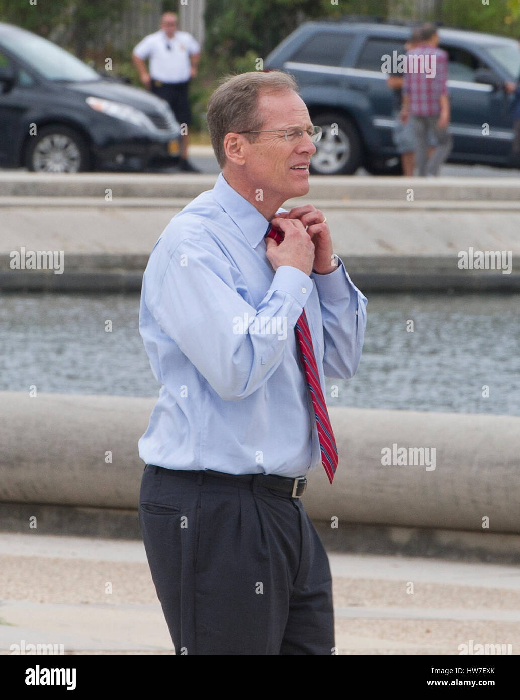 United States Representative Jack Kingston (Democrat of Georgia) loosens his tie as he prepares to work on bit with Stephen Colbert host of the Comedy Central show 'The Colbert Report' around the the U.S. Capitol Reflecting Pool in Washington D.C. on Frid Stock Photo