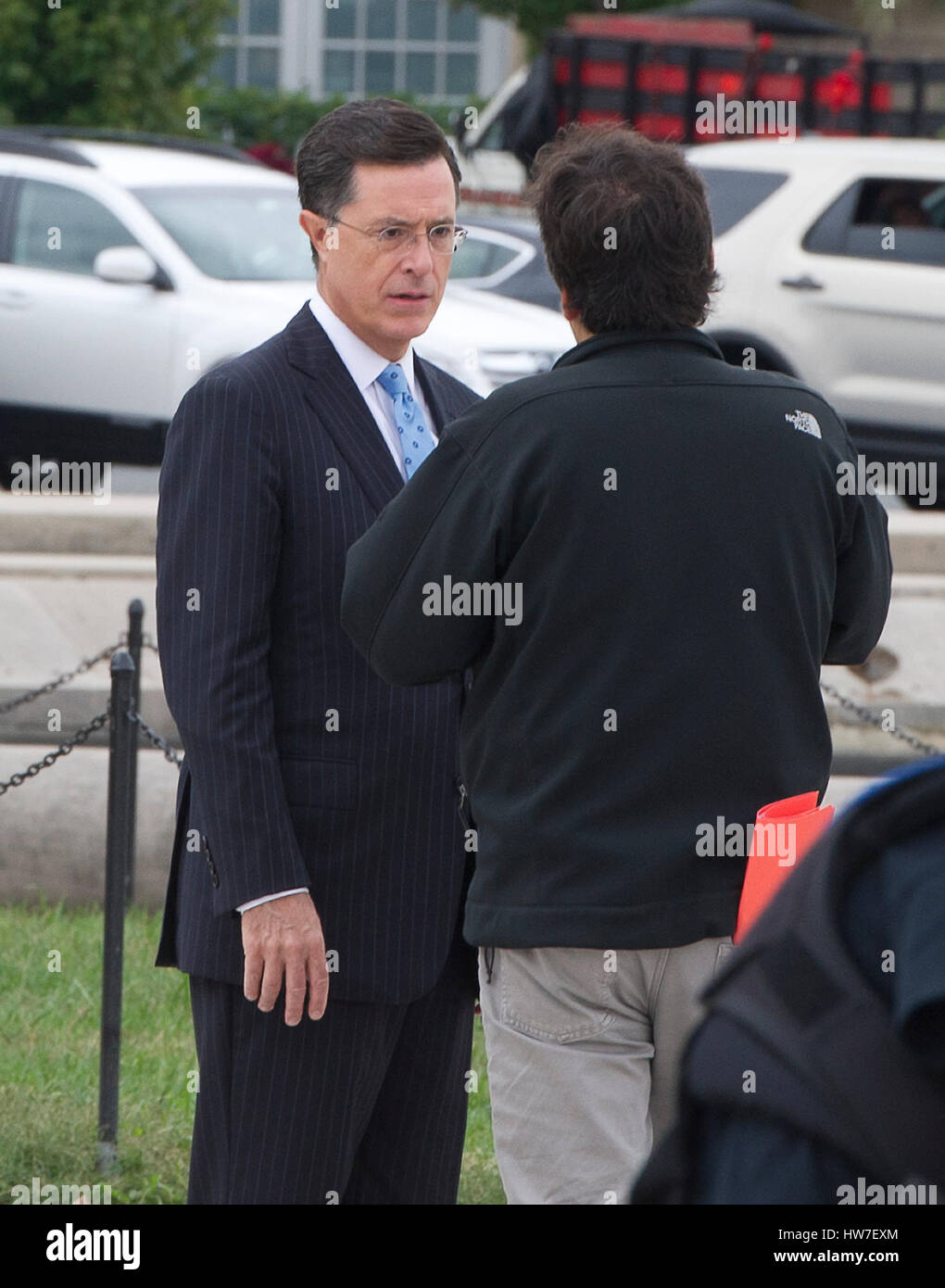 Stephen Colbert host of the Comedy Central show 'The Colbert Report' speaks with an unidentified director as he works on bit with United States Representative Jack Kingston (Democrat of Georgia) around the the U.S. Capitol Reflecting Pool in Washington D. Stock Photo