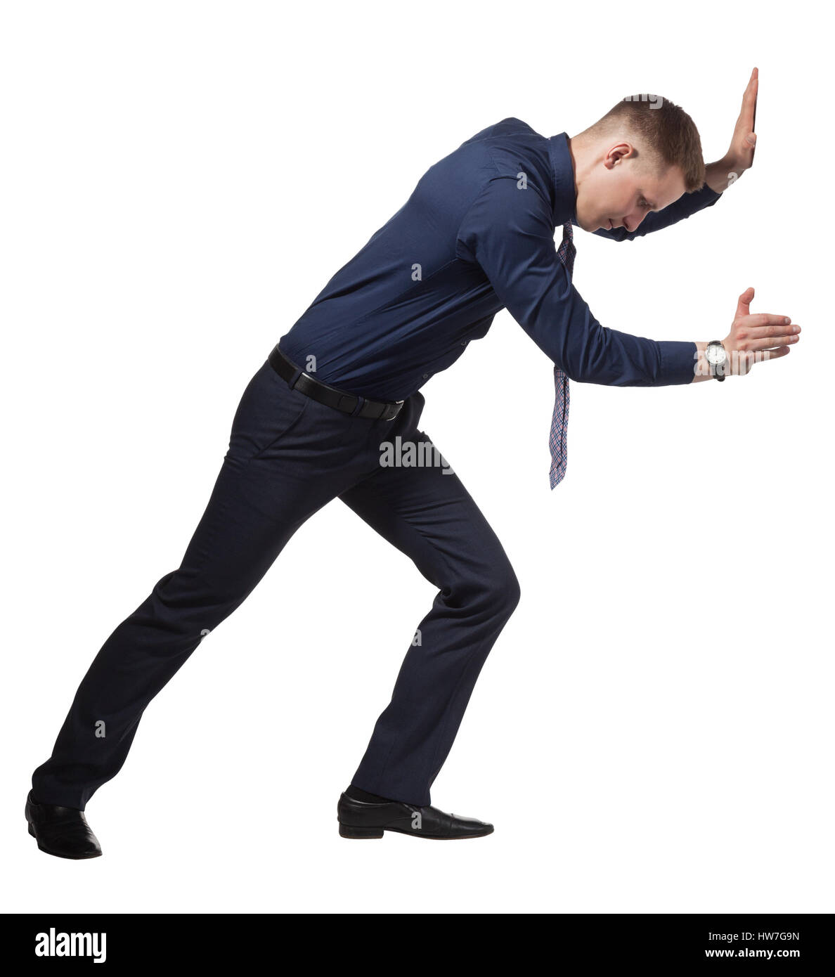 Young Businessman pushing wall, on white Stock Photo