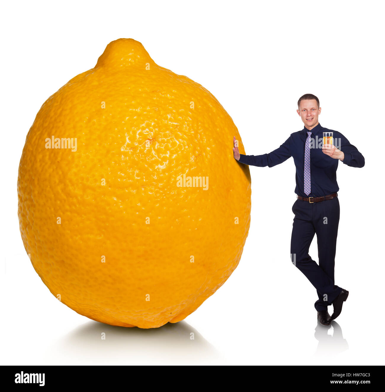 young-man-with-lemonade-stands-next-to-huge-lemon-HW7GC3.jpg