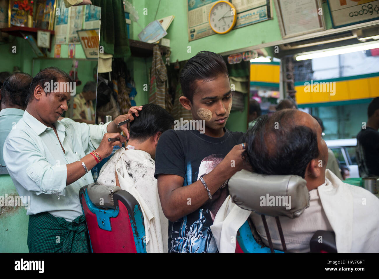 26.01.2017, Yangon, Republic of the Union of Myanmar, Asia - Two barbers are seen cutting the hair of clients in Yangon. Stock Photo