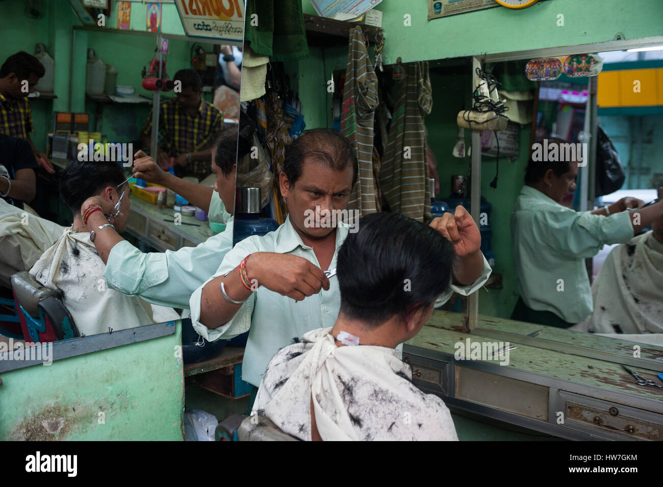 26.01.2017, Yangon, Republic of the Union of Myanmar, Asia - A barber is seen cutting the hair of a client in Yangon. Stock Photo