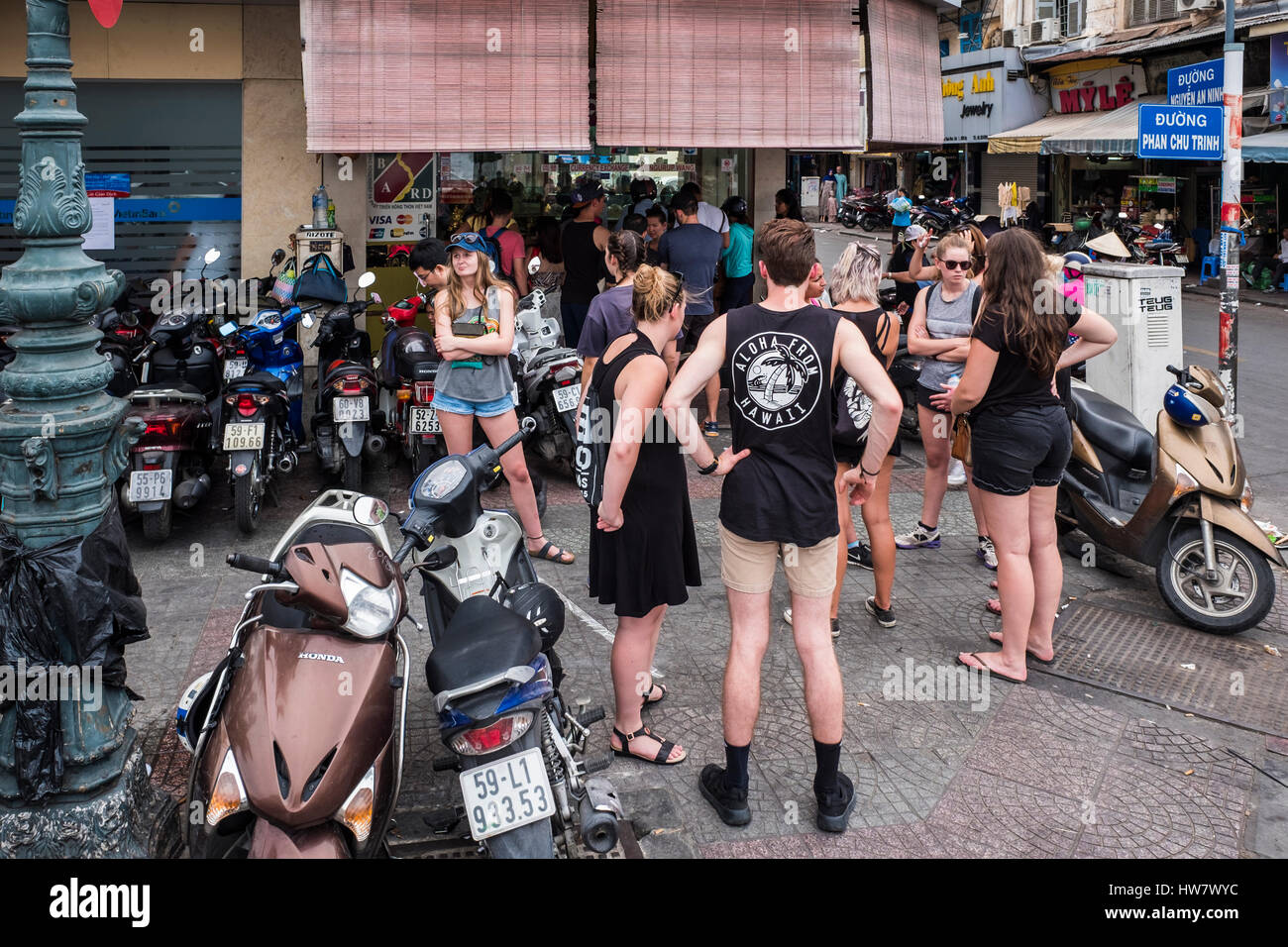 Foreign tourists gather outside of a shop, Ho Chi Minh City, Vietnam Stock Photo