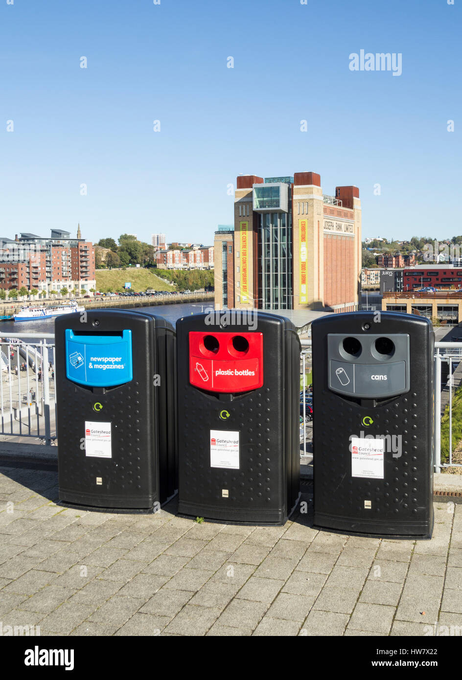 Colour coded recycling bins outside The Gateshead Sage. Baltic arts centre in background