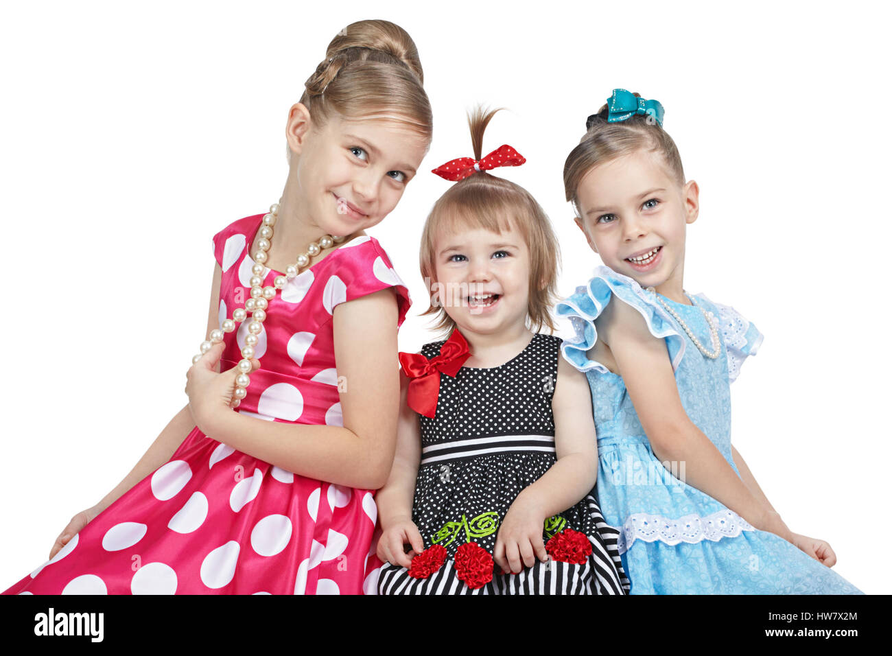 Portrait of three cheerful sisters on a white background Stock Photo