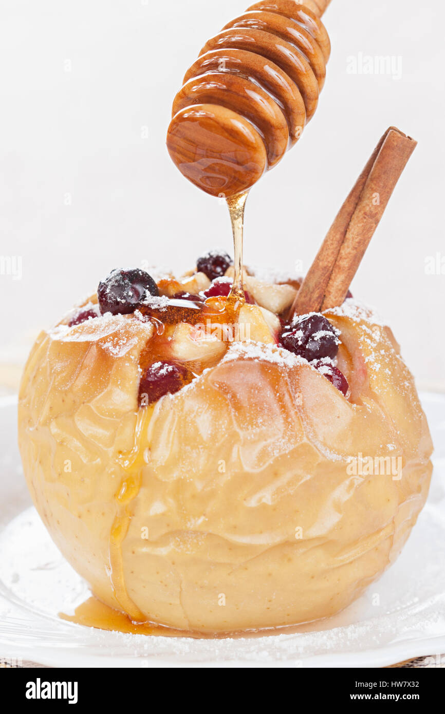 The apple baked with a cranberry is watered honey Stock Photo