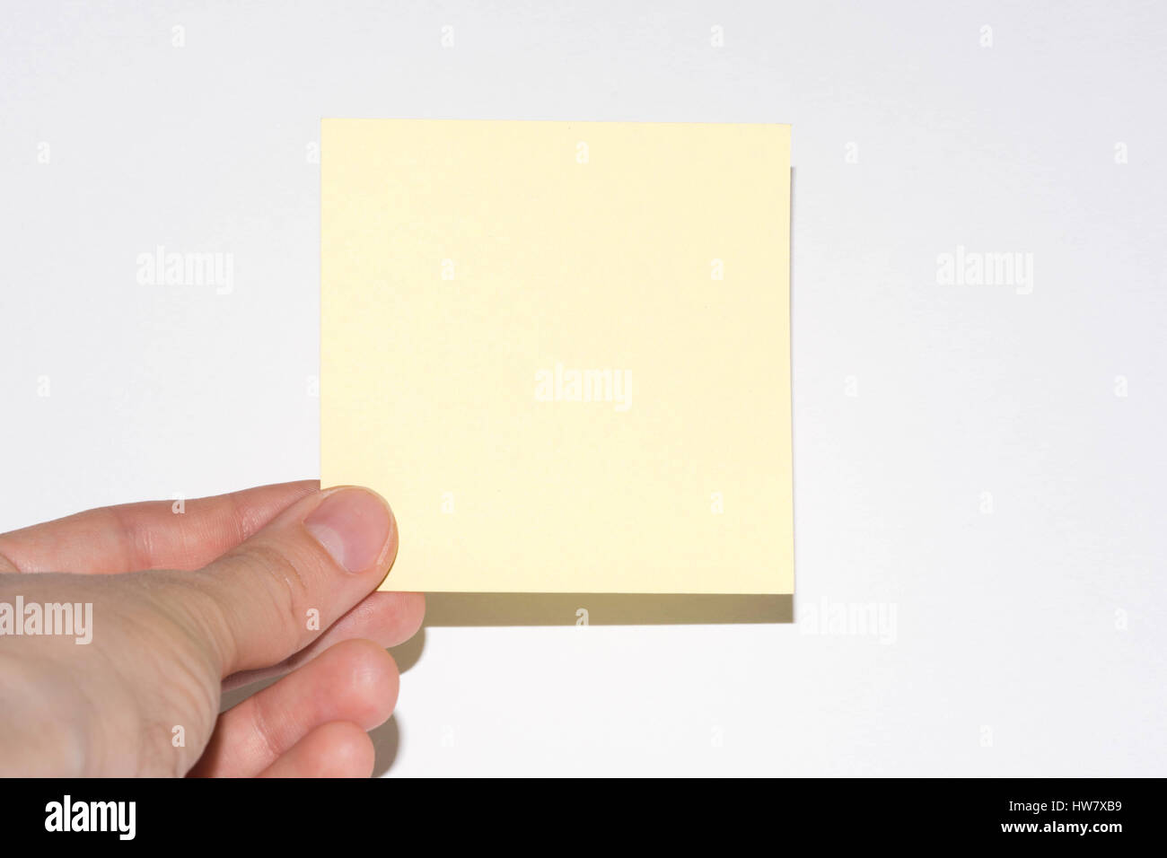 stick note isolated on white background. Yellow post-it note with hand ...