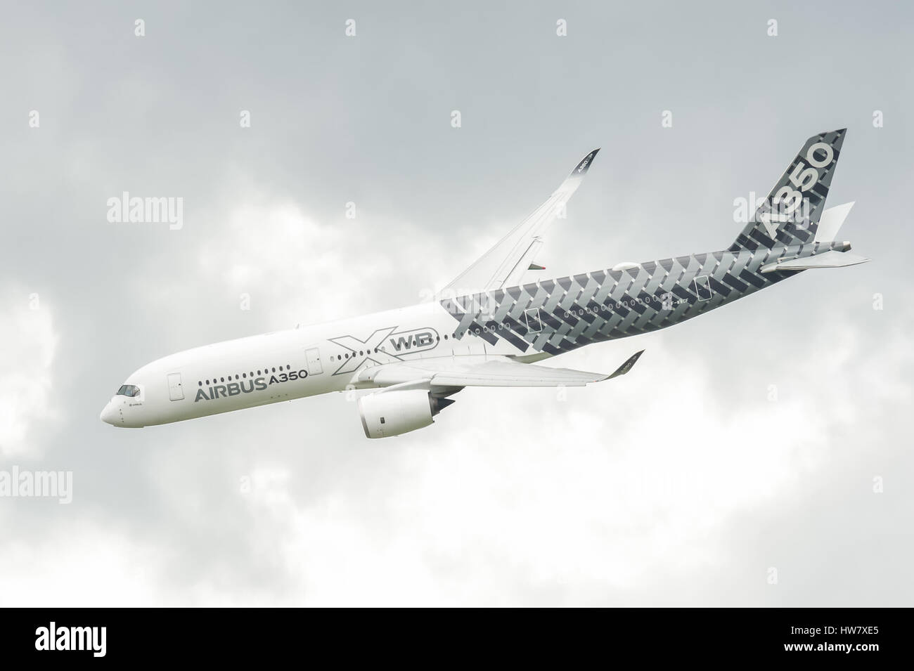 Airbus A350-941 circling in cloudy skies before landing at Farnborough, Hampshire, UK Stock Photo