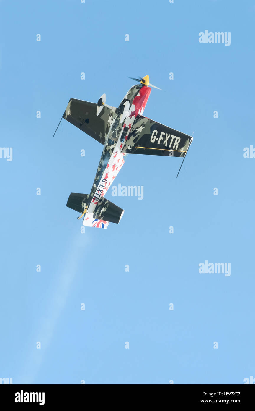 Loop the loop maneuver by a Global Stars formation aerobatic display pilot in the skies over Farnborough, Hampshire, UK Stock Photo