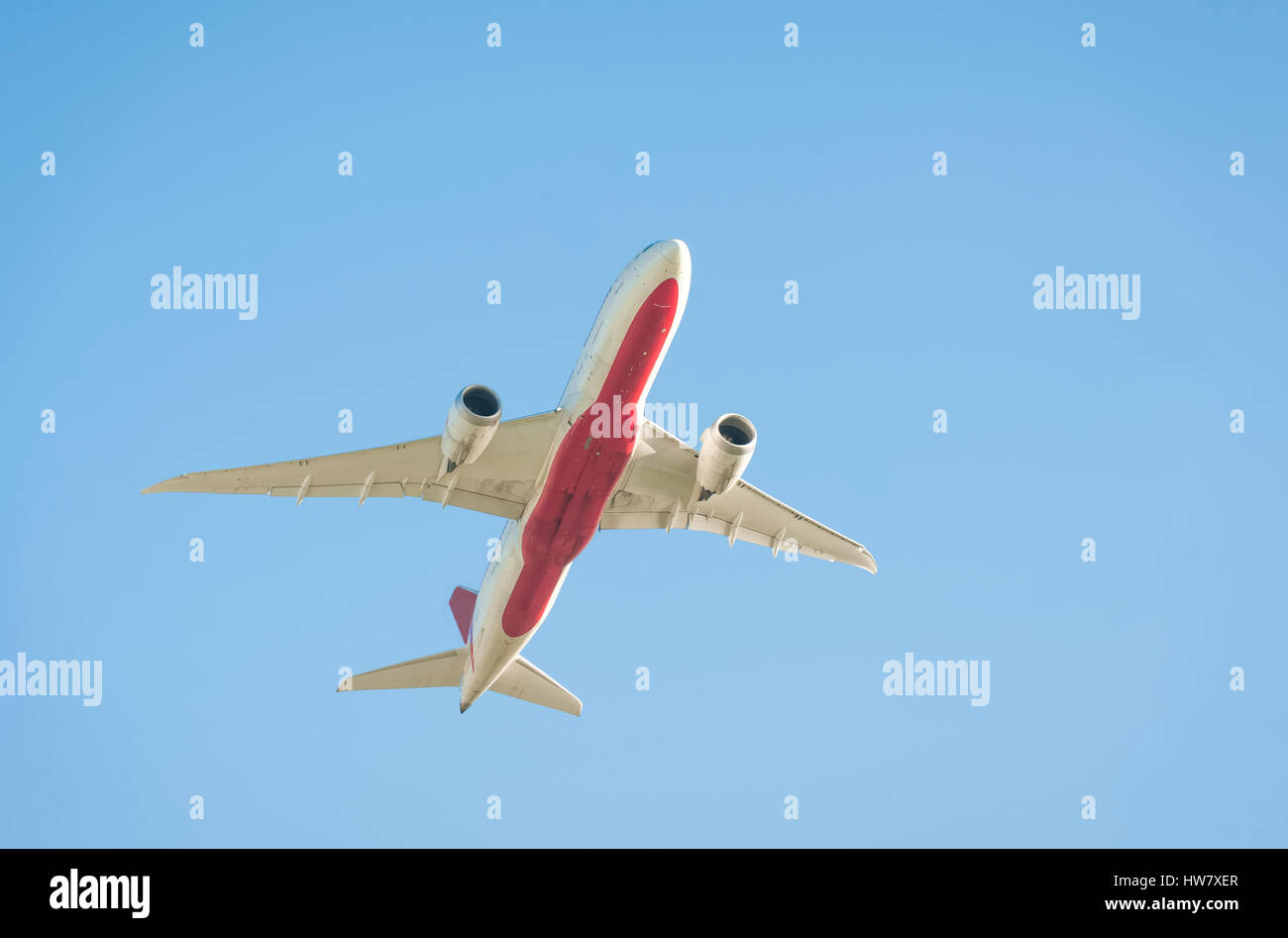 passenger jet silhouette against a clear blue sky Stock Photo