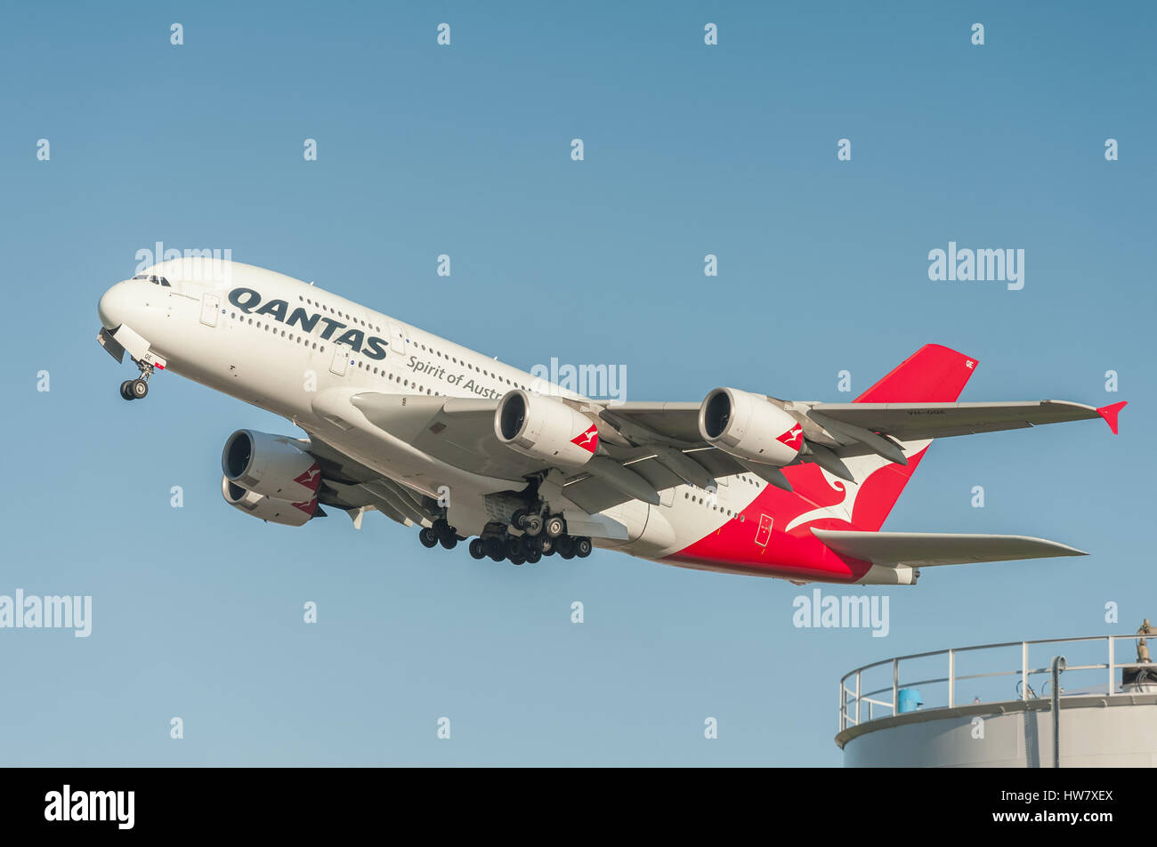 A five hundred seat Qantas Airbus A380 departing into a crystal clear blue sky from Heathrow Airport, London, Stock Photo