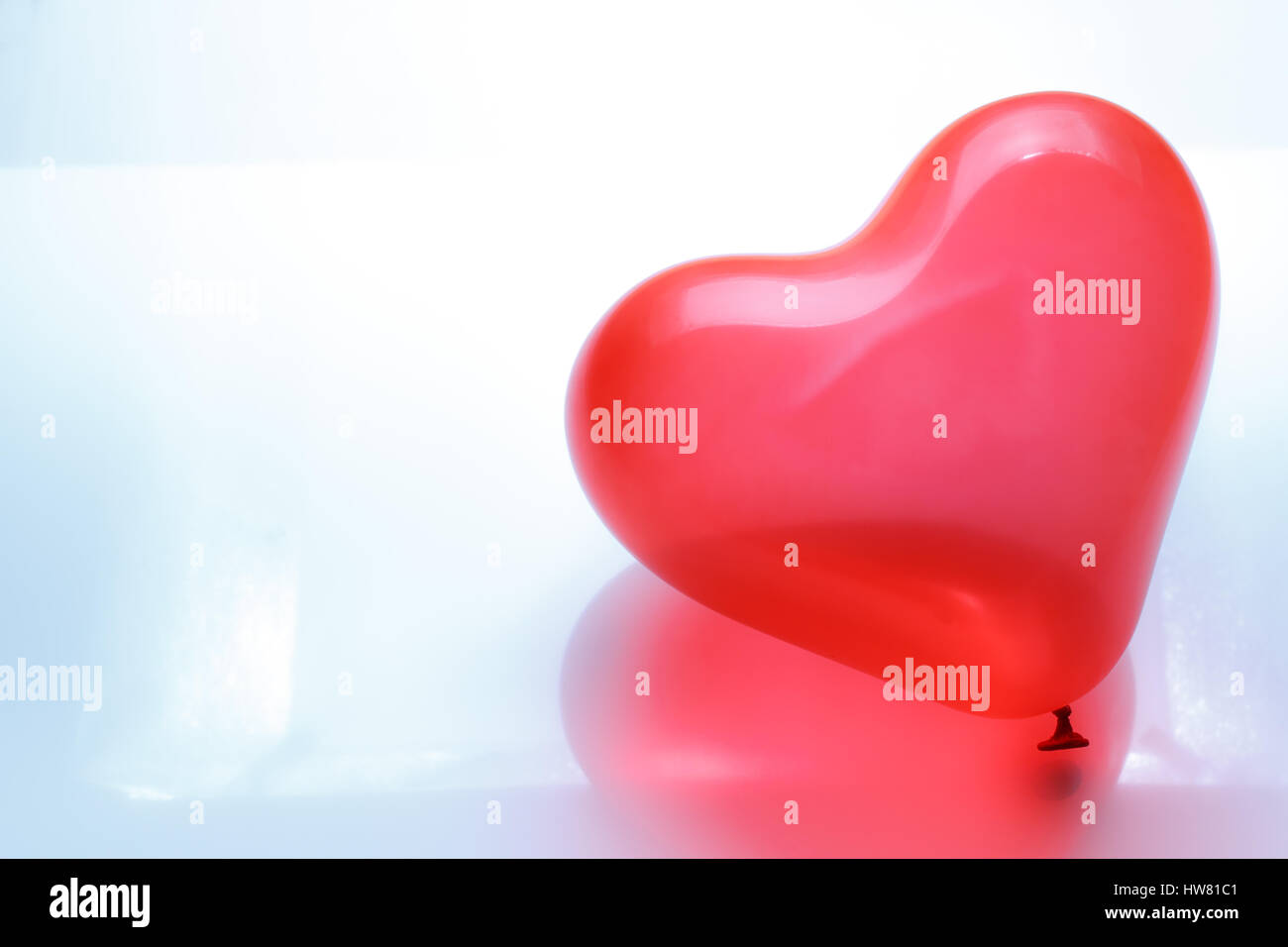 Red heart shaped balloon on white background Stock Photo - Alamy