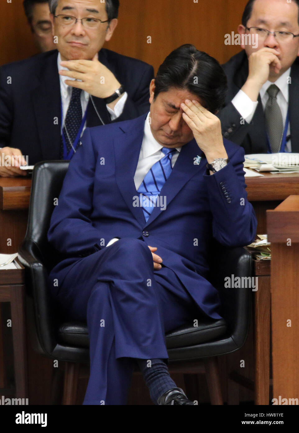 Tokyo, Japan. 17th Mar, 2017. Japanese Prime Minister Shinzo Abe listens to a question by an opposition lawmaker at the Lower House's foreign affairs committee session at the National Diet in Tokyo on Friday, March 17, 2017. Abe is now center in a land deal scandal of a Osaka elementary school as he donated to the school operator Yasunori Kagoike, news reported. Credit: Yoshio Tsunoda/AFLO/Alamy Live News Stock Photo