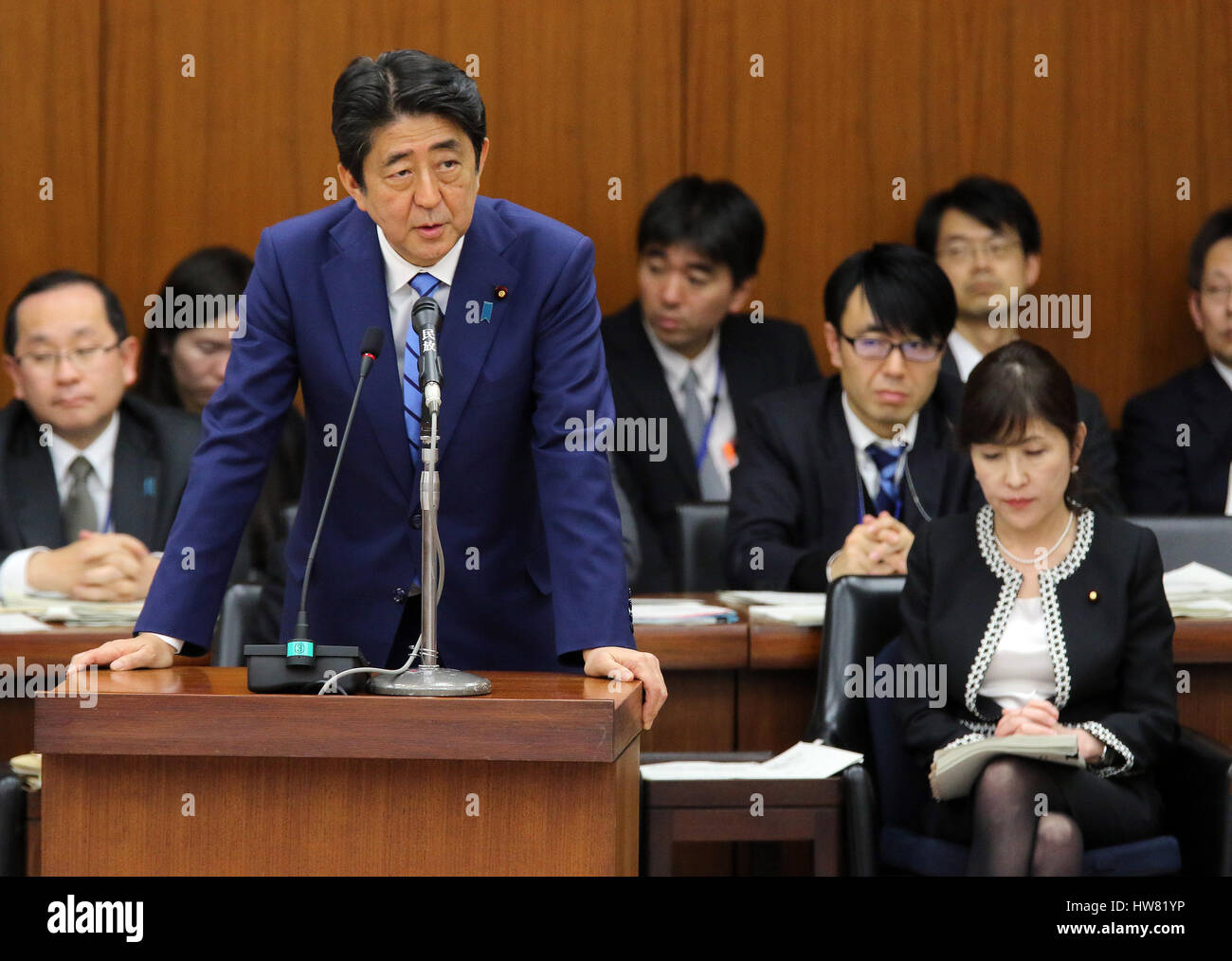 Tokyo, Japan. 17th Mar, 2017. Japanese Prime Minister Shinzo Abe answers a question by an opposition lawmaker at the Lower House's foreign affairs committee session at the National Diet in Tokyo on Friday, March 17, 2017, while Defense Minister Tomomi Inada (R) looks on. Abe is now center in a land deal scandal of a Osaka elementary school as he donated to the school operator Yasunori Kagoike, news reported. Credit: Yoshio Tsunoda/AFLO/Alamy Live News Stock Photo