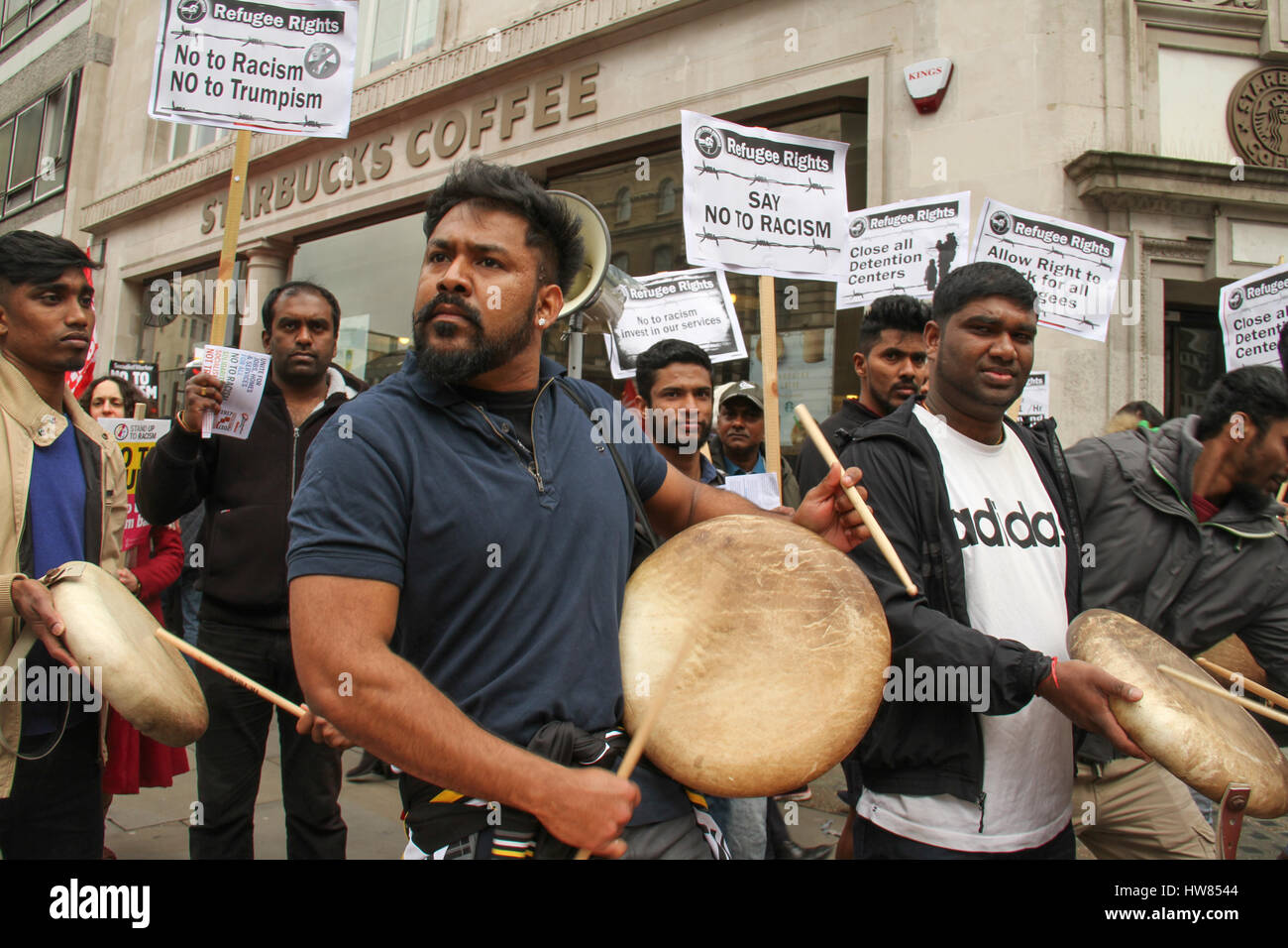 London, UK. March 18, 2017: Indian immigrants drum and chant as they prepare to participate in the Stand Up To Racism demonstration on UN Anti-Racism Day in the streets of London on March 18, 2017. The march began at Portland Place (BBC) and ended at Parliament Square, where a rally is scheduled. The UN Anti-Racism Day is a global day of action against racism in all its forms. © David Mbiyu/Alamy Live News Stock Photo