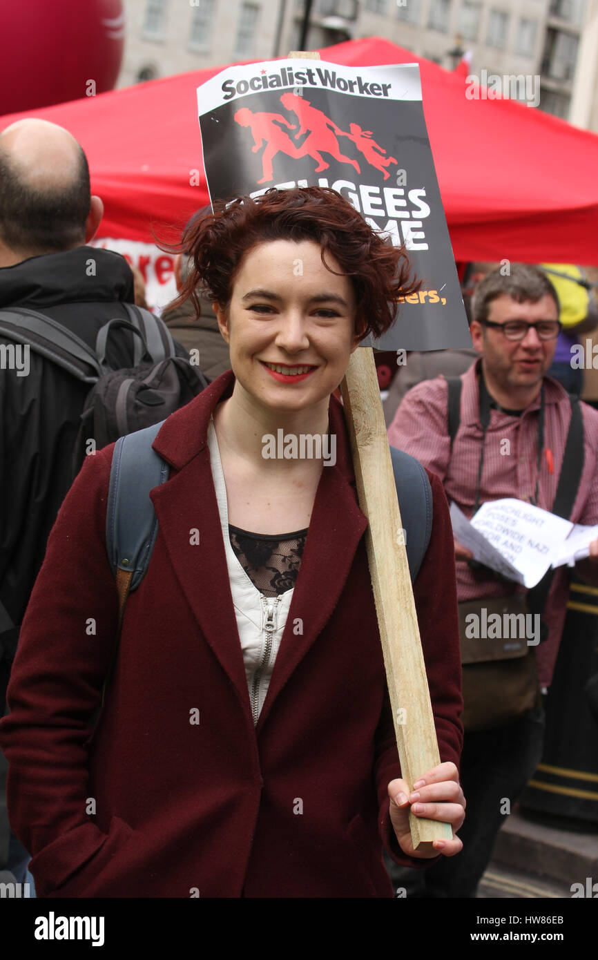 London, UK. March 18, 2017: A demonstrator with a "socialist Worker' plcards seen ahed of the  Stand Up To Racism demonstration on UN Anti-Racism Day in the streets of London on March 18, 2017. The march began at Portland Place (BBC) and ended at Parliament Square, where a rally is scheduled. The UN Anti-Racism Day is a global day of action against racism in all its forms. © David Mbiyu/Alamy Live News Stock Photo