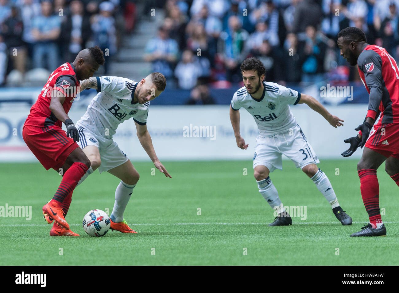 Vancouver, Canada. 18 March, 2017. Jordan Harvey #2 of Vancouver Whitecaps challenging  Armando Cooper #31 of Toronto FC. Vancouver Whitecaps vs Toronto FC, BC Place Stadium. Toronto defeats Vancouver 2-0, with goals from Victor Vasquez #7 and Jozy Altidore #17 of Toronto FC  © Gerry Rousseau/Alamy Live News Stock Photo