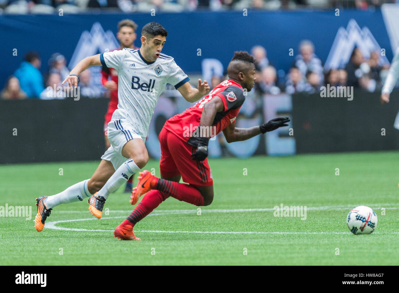 Vancouver, Canada. 18 March, 2017. Matias Laba #15 of the Vancouver Whitecaps, and Armando Cooper #31 of Toronto FC. going for the ball. Vancouver Whitecaps vs Toronto FC, BC Place Stadium. Toronto defeats Vancouver 2-0, with goals from Victor Vasquez #7 and Jozy Altidore #17 of Toronto FC  © Gerry Rousseau/Alamy Live News Stock Photo