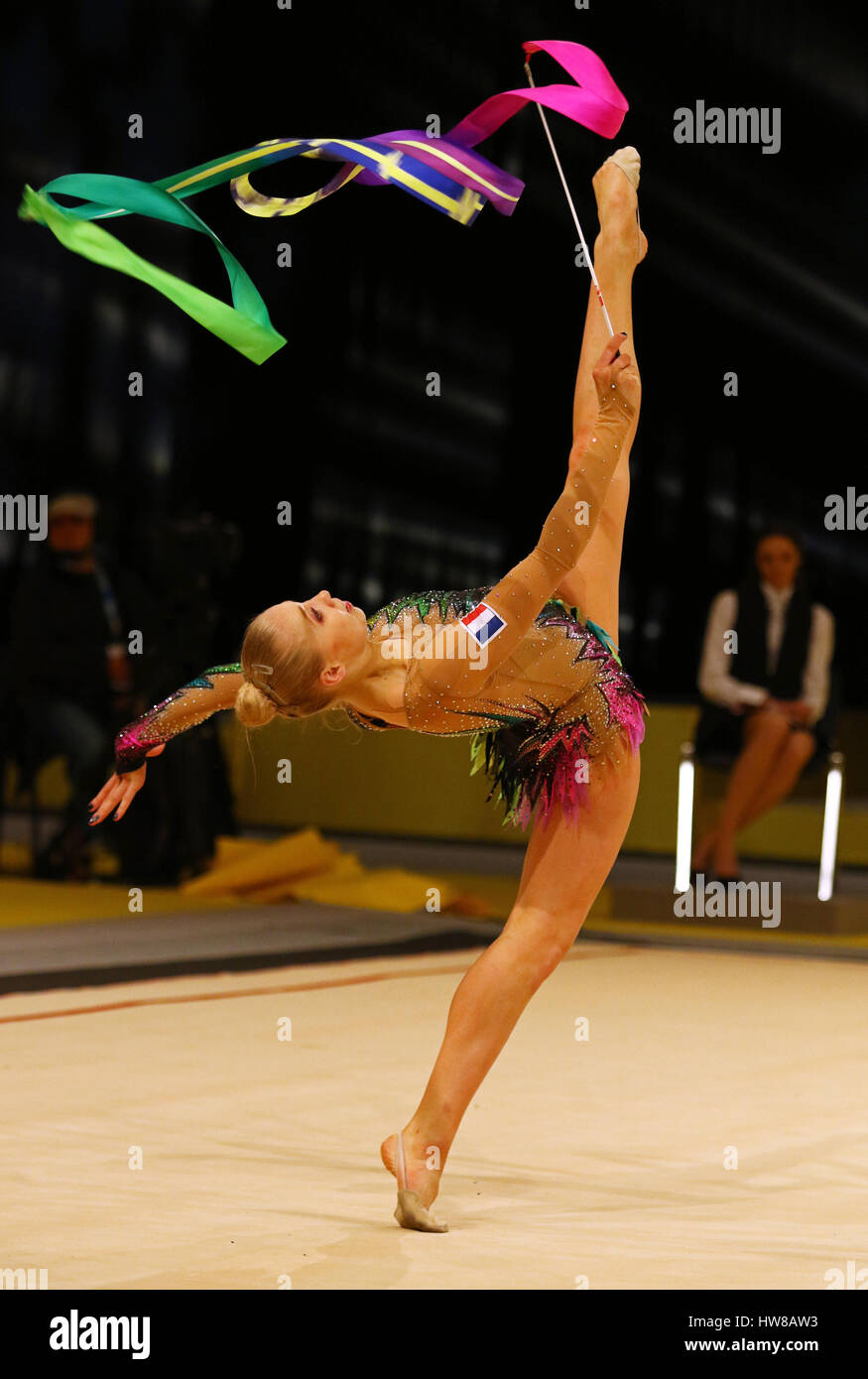 Beautiful Female Rhythmic Gymnast with Clubs Behind Her Back Isolated on  Multicolored Neon Background. Stock Photo - Image of grace, background:  225428030